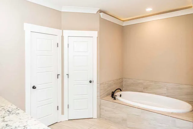 a bathroom with a tub a sink and a shower
