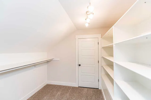 a view of walk in closet with empty racks