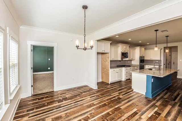 a view of kitchen with sink and refrigerator