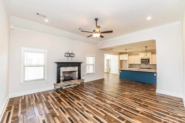 a view of an empty room with a fireplace and a window