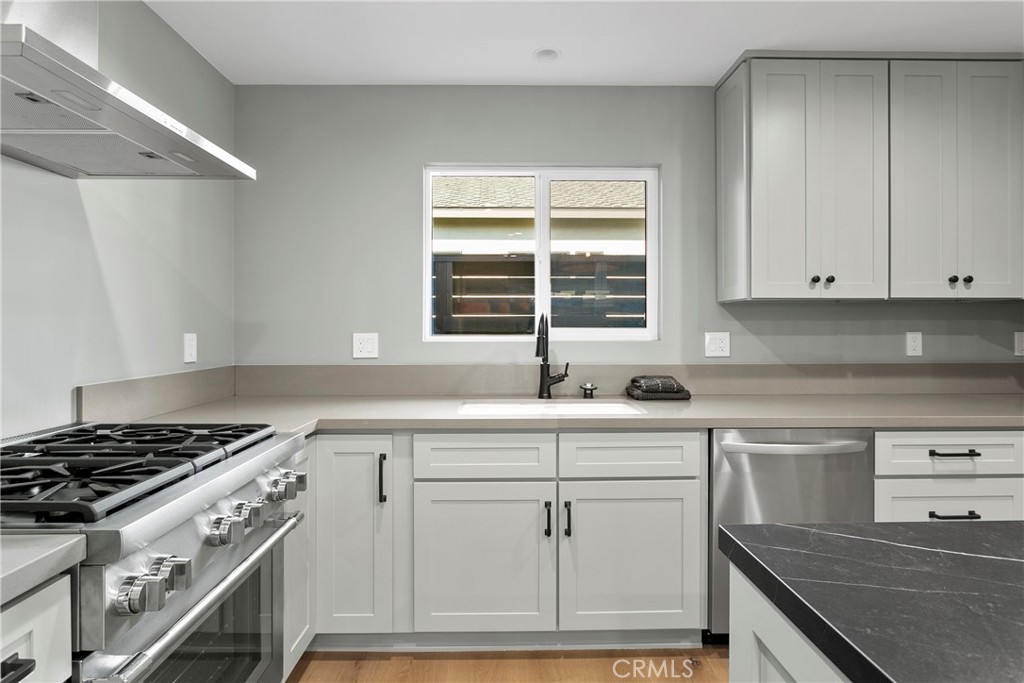 a kitchen with granite countertop white cabinets and white appliances