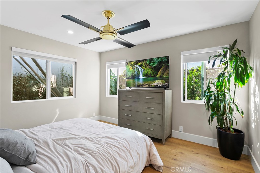 354 La Perle Place, Unit B Costa Mesa, CA 92627 - Photo 12 of 16 a bedroom with a bed and a potted plant