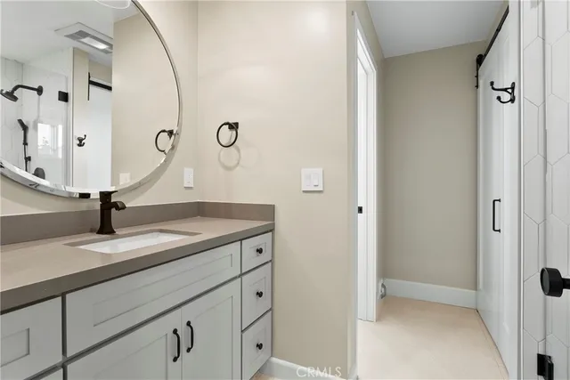 a view of a bathroom with a sink and mirror
