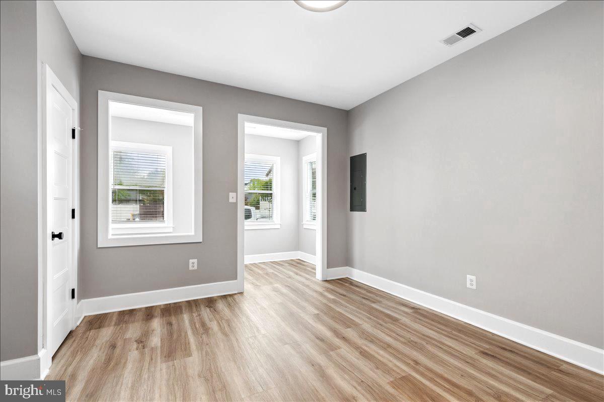 1621 Bentley Road Edgewater, MD 21037 - Photo 9 of 17 a view of an empty room with wooden floor and a window