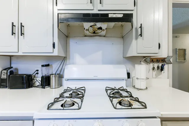 a kitchen with a refrigerator and cabinets