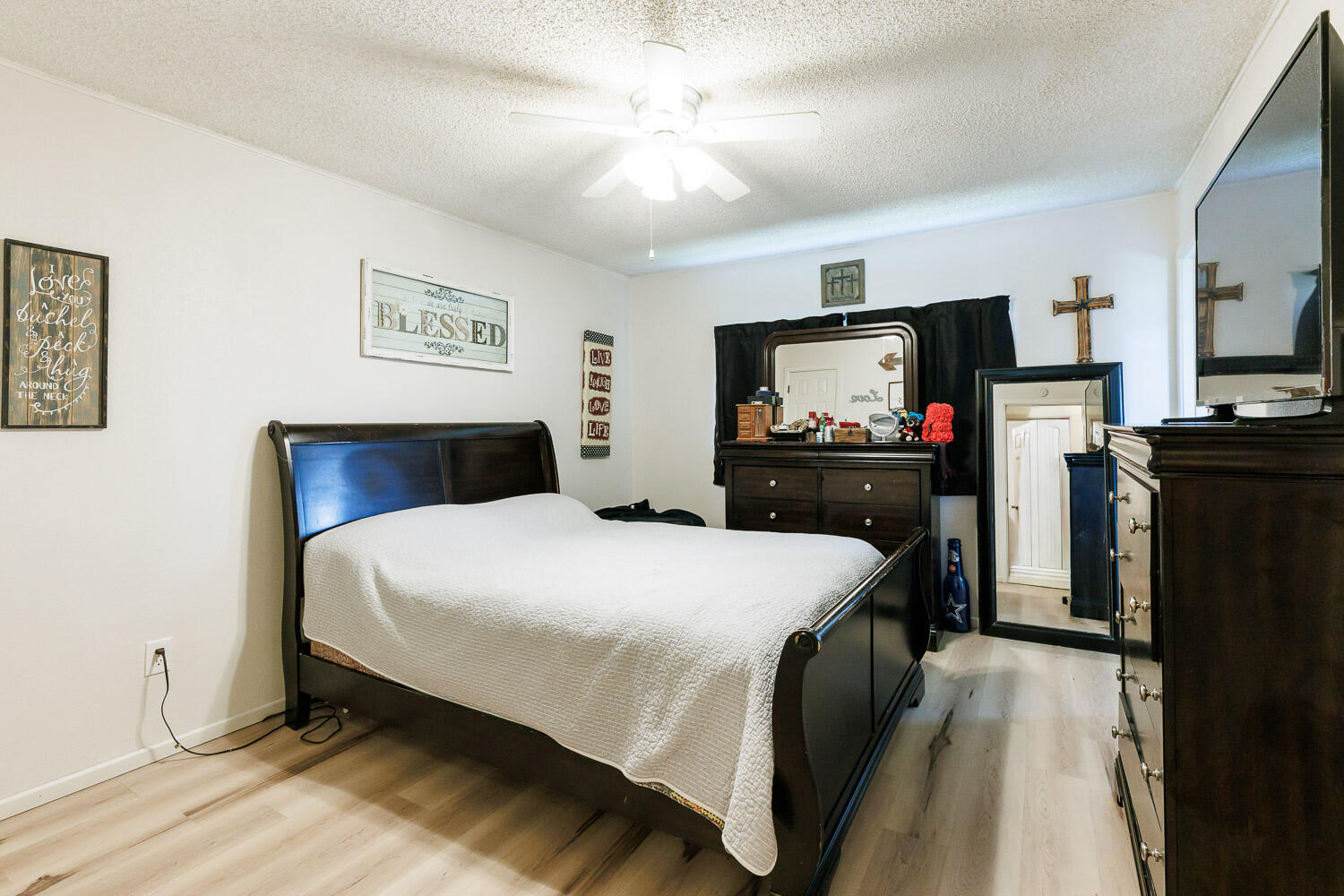 4609 Kemper Street Lubbock, TX 79416 - Photo 15 of 33 a bedroom with a bed and a flat screen tv