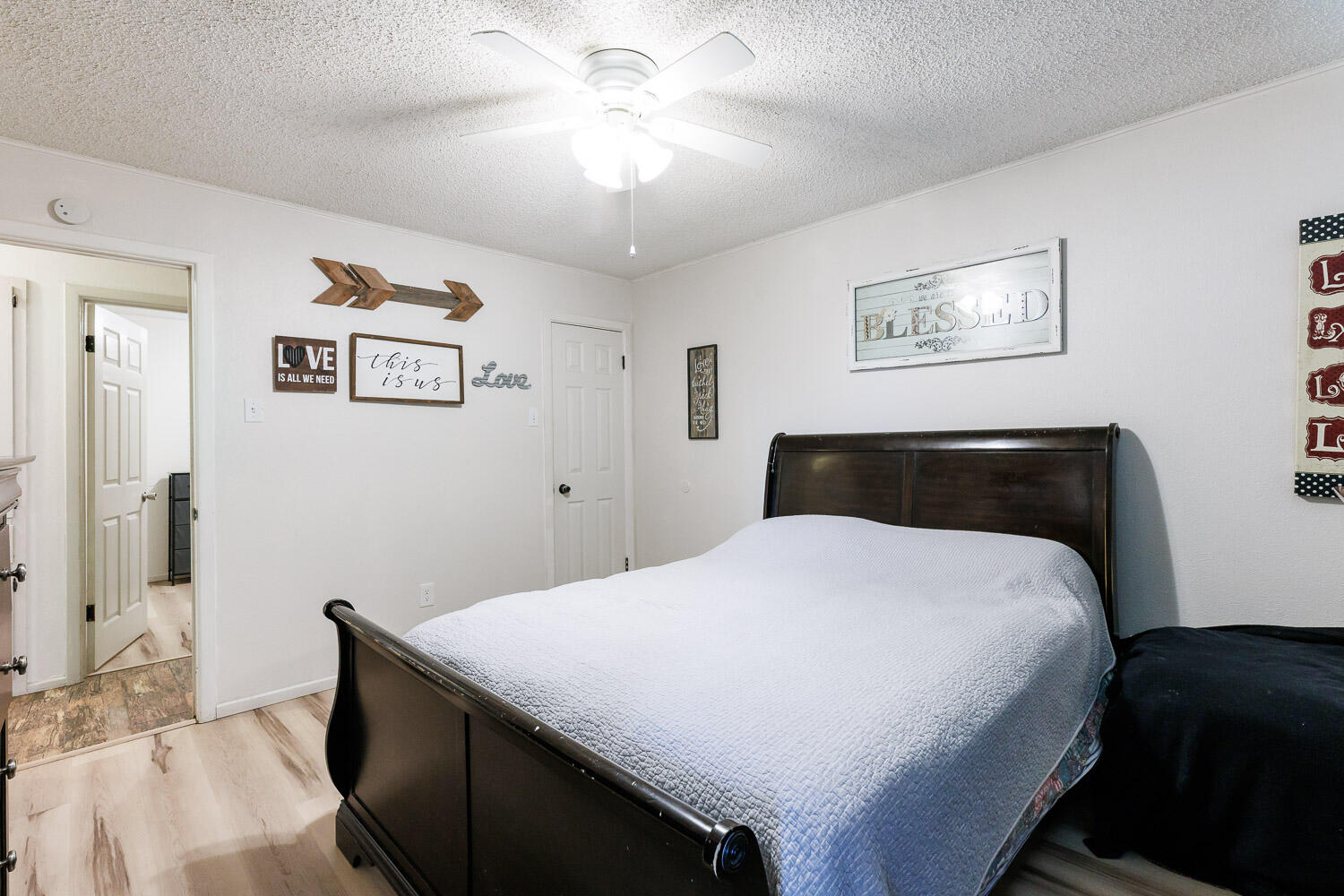 4609 Kemper Street Lubbock, TX 79416 - Photo 16 of 33 a bedroom with a bed and a chandelier