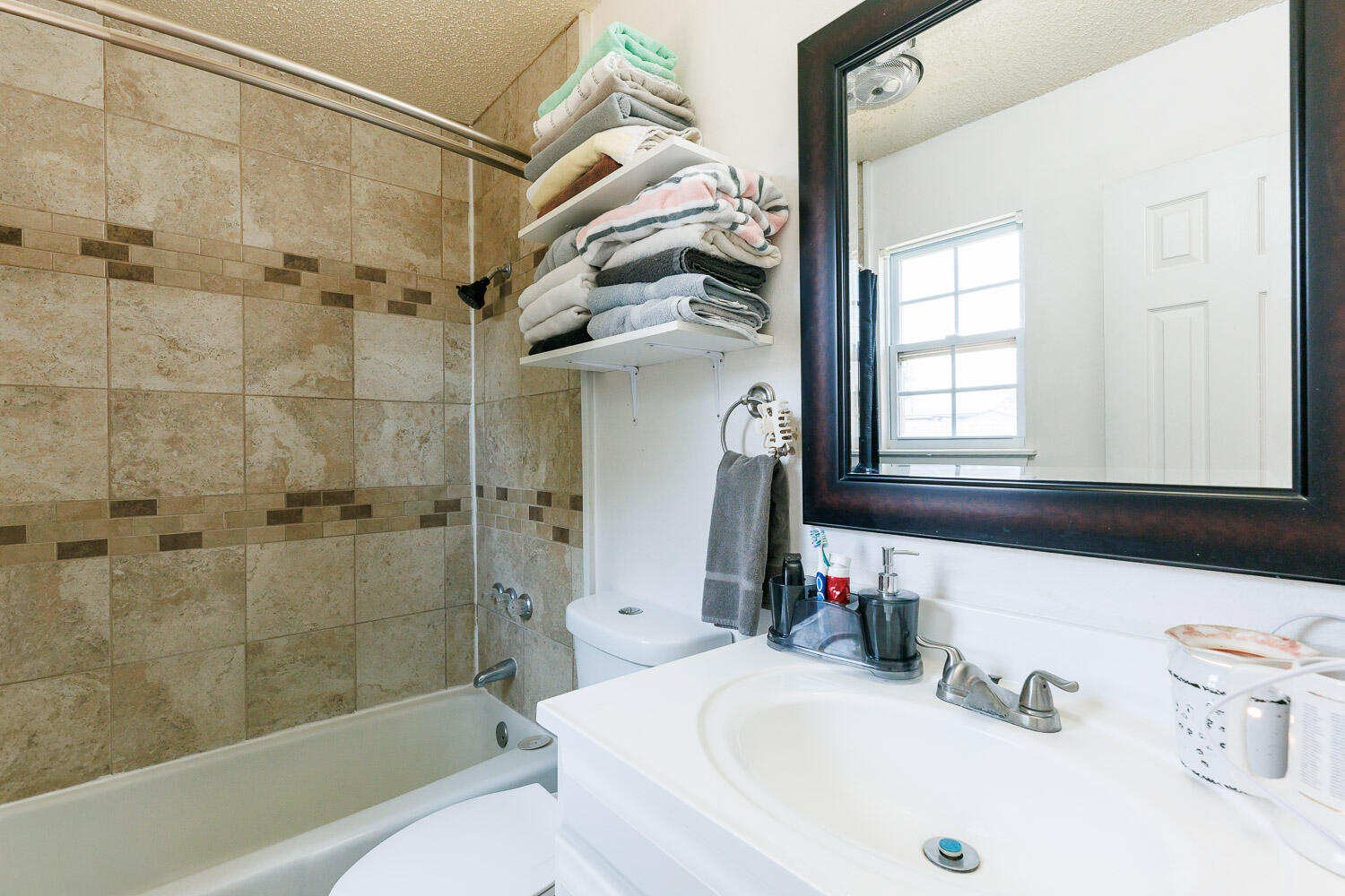 4609 Kemper Street Lubbock, TX 79416 - Photo 17 of 33 a bathroom with a sink a toilet and shower
