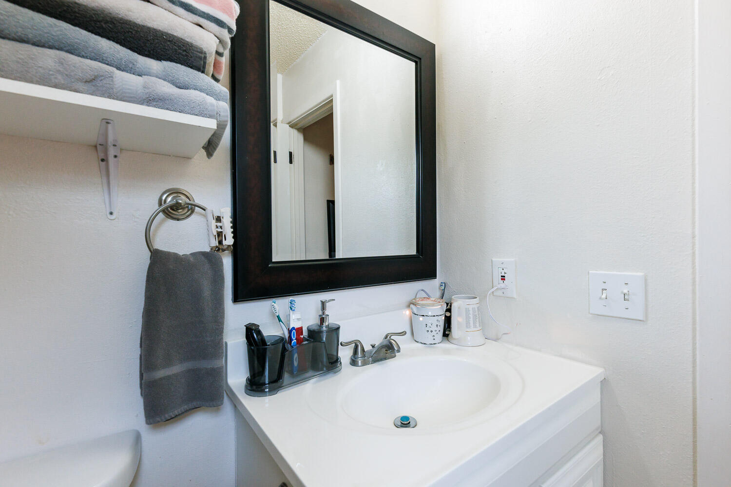 4609 Kemper Street Lubbock, TX 79416 - Photo 19 of 33 a bathroom with a sink and a mirror