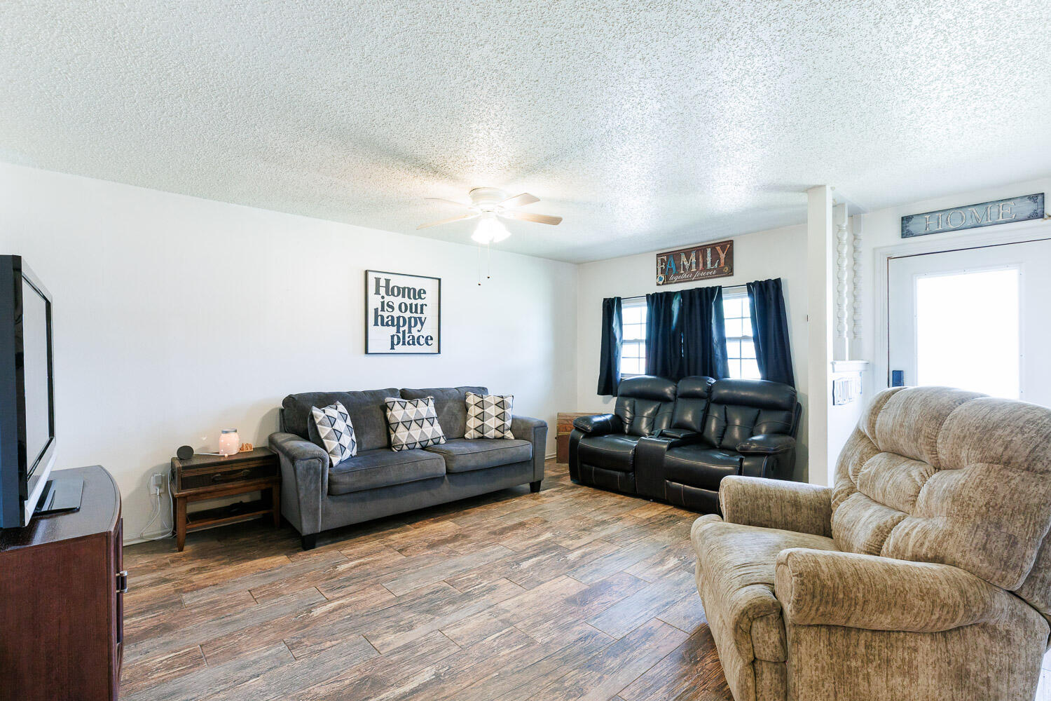 4609 Kemper Street Lubbock, TX 79416 - Photo 2 of 33 a living room with furniture ceiling fan and a wooden floor