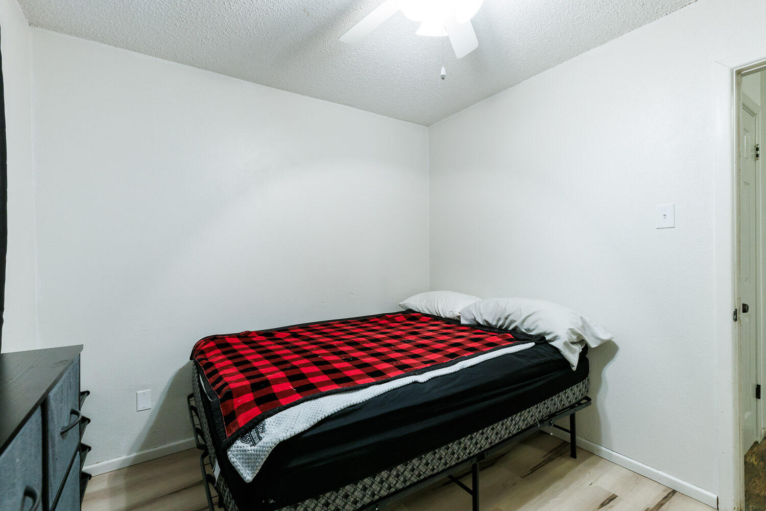 4609 Kemper Street Lubbock, TX 79416 - Photo 22 of 33 a bedroom with a bed and wooden floor