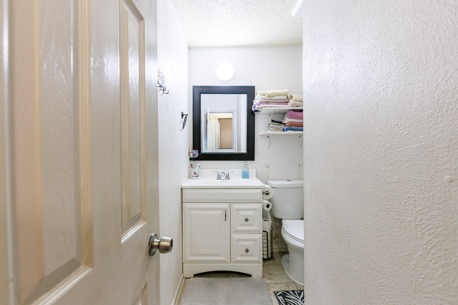 4609 Kemper Street Lubbock, TX 79416 - Photo 24 of 33 a bathroom with a toilet sink and mirror