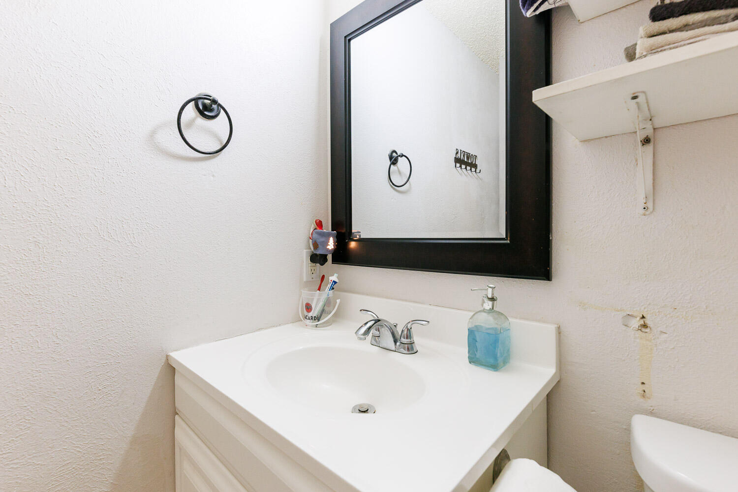 4609 Kemper Street Lubbock, TX 79416 - Photo 25 of 33 a bathroom with a sink and a mirror