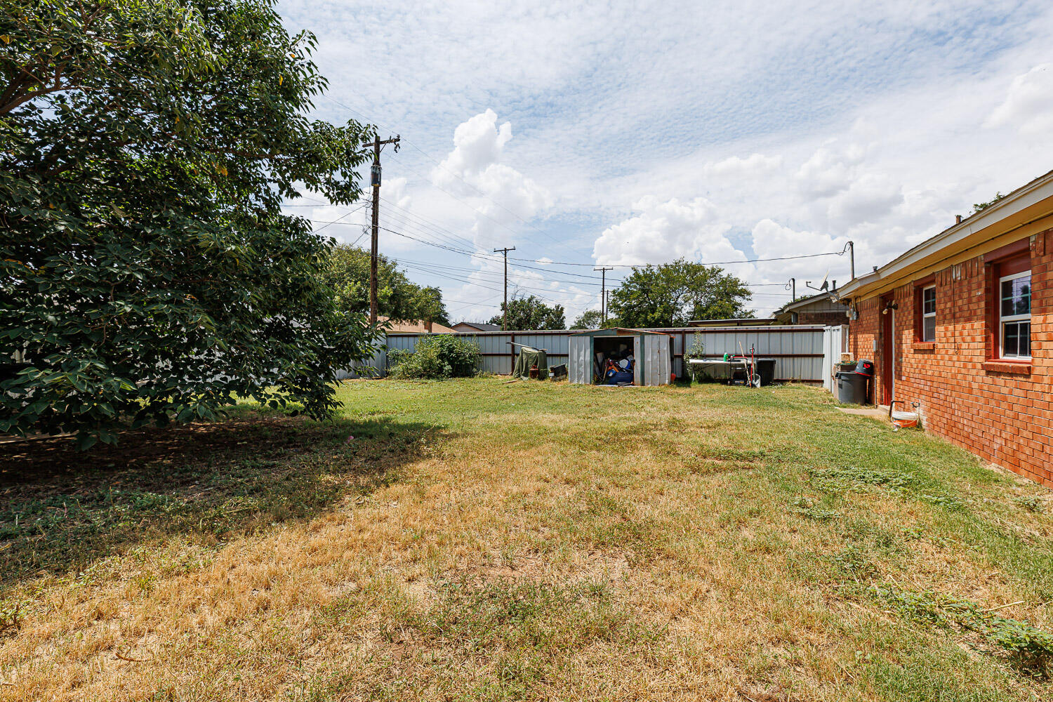 4609 Kemper Street Lubbock, TX 79416 - Photo 33 of 33 a backyard of a house with a yard and outdoor seating