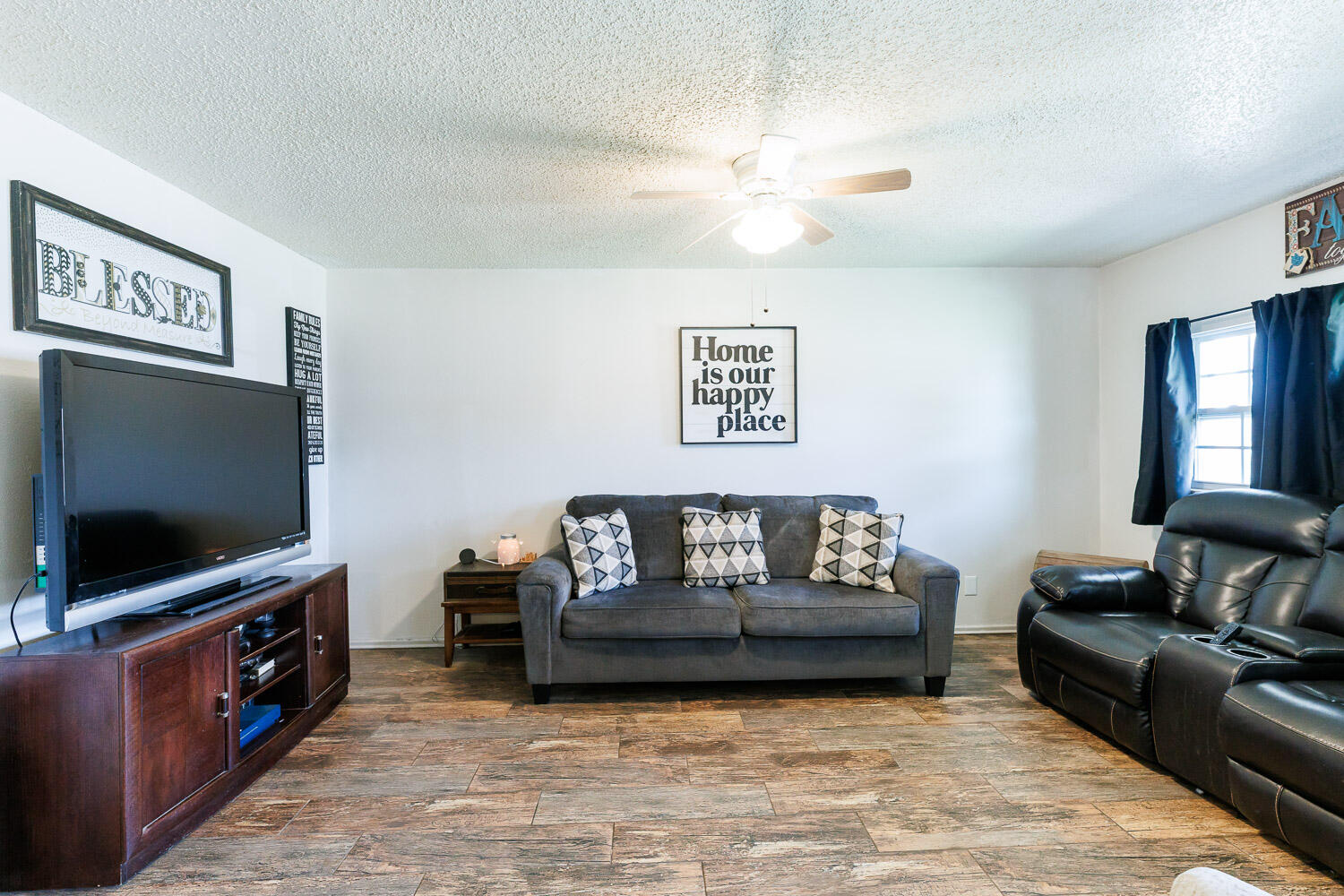 4609 Kemper Street Lubbock, TX 79416 - Photo 9 of 33 a living room with furniture and a flat screen tv