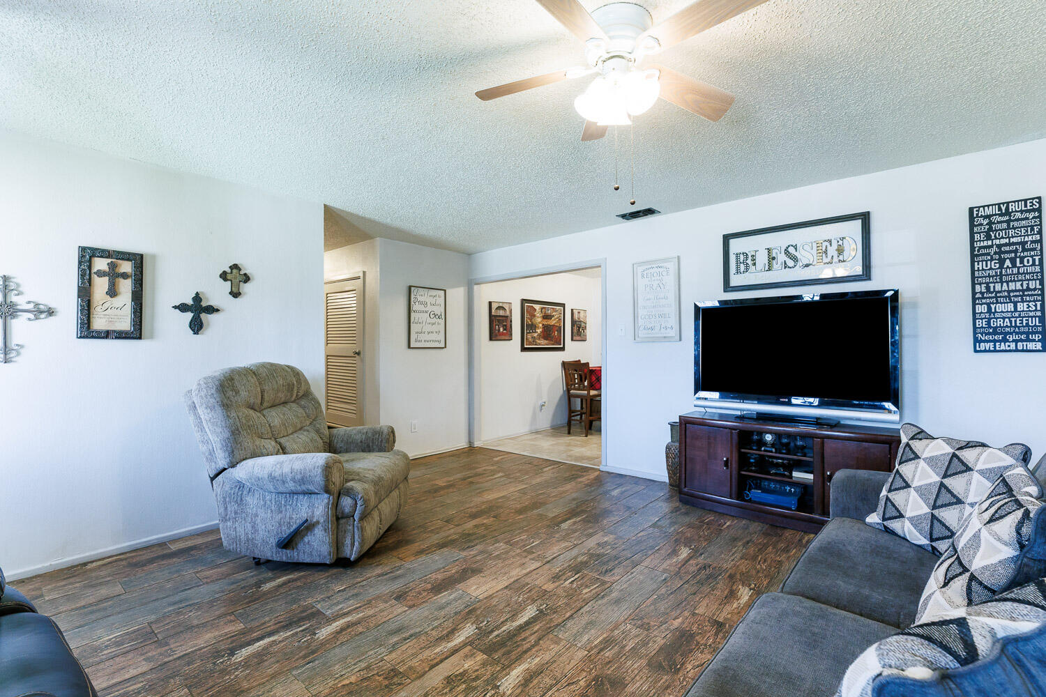 4609 Kemper Street Lubbock, TX 79416 - Photo 10 of 33 a living room with furniture and a flat screen tv