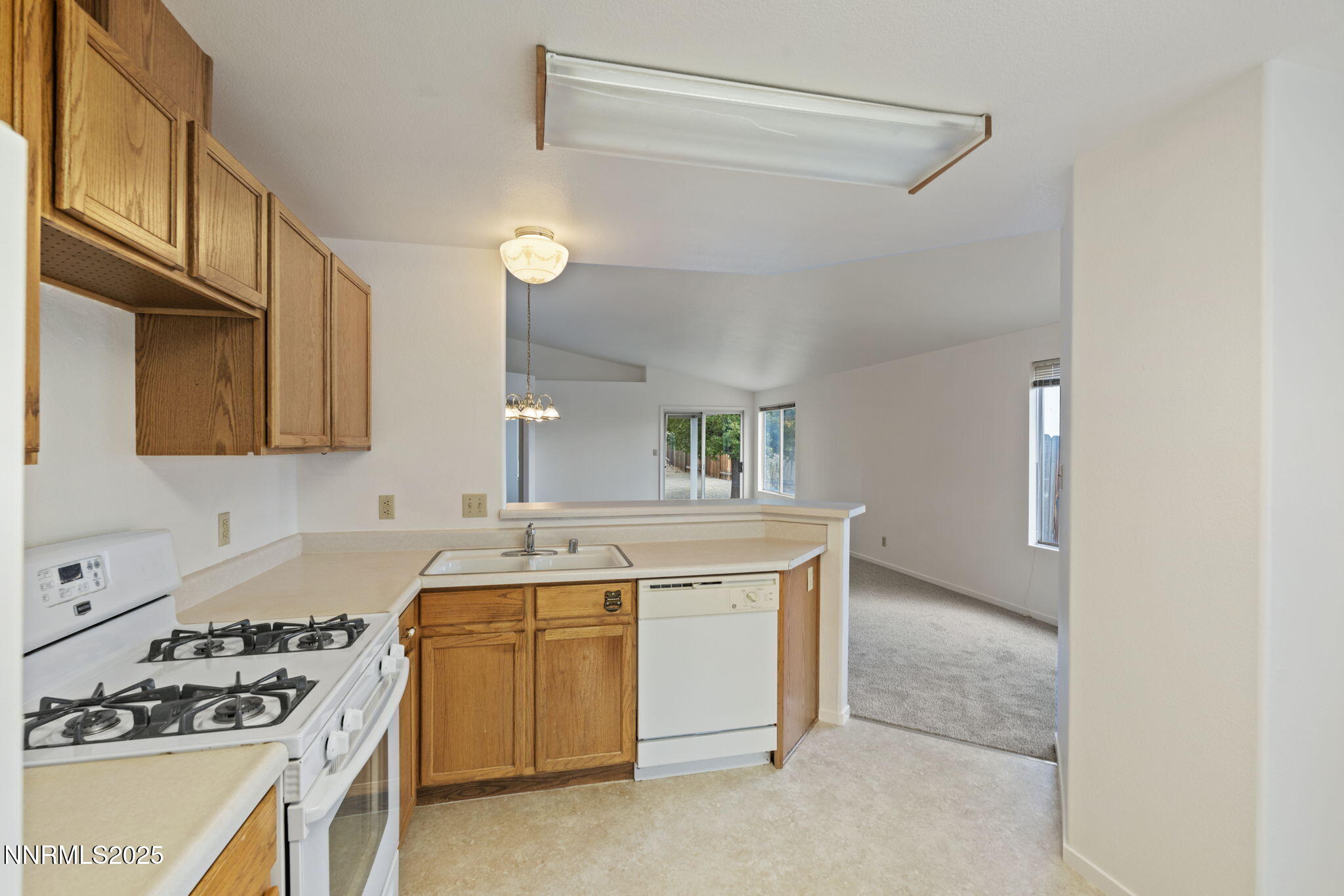 6811 Sonterra Lane Reno, NV 89523 - Photo 7 of 25 a kitchen with a stove and a sink