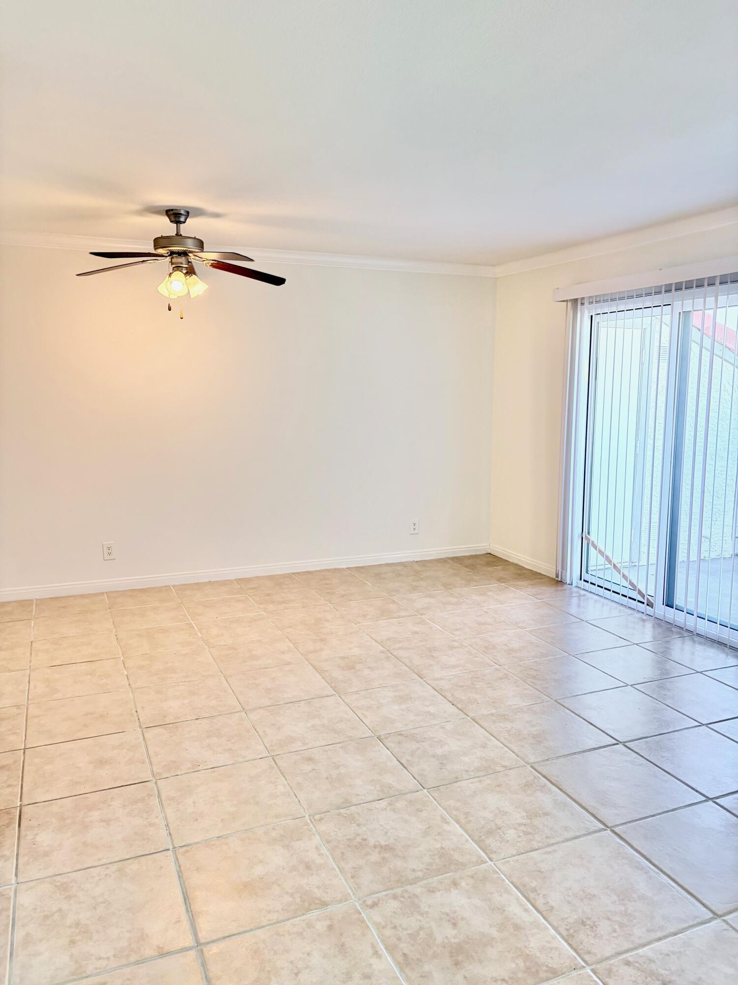 43376 Cook Street, Unit 32 Palm Desert, CA 92211 - Photo 11 of 31 an empty room with a ceiling fan and a window