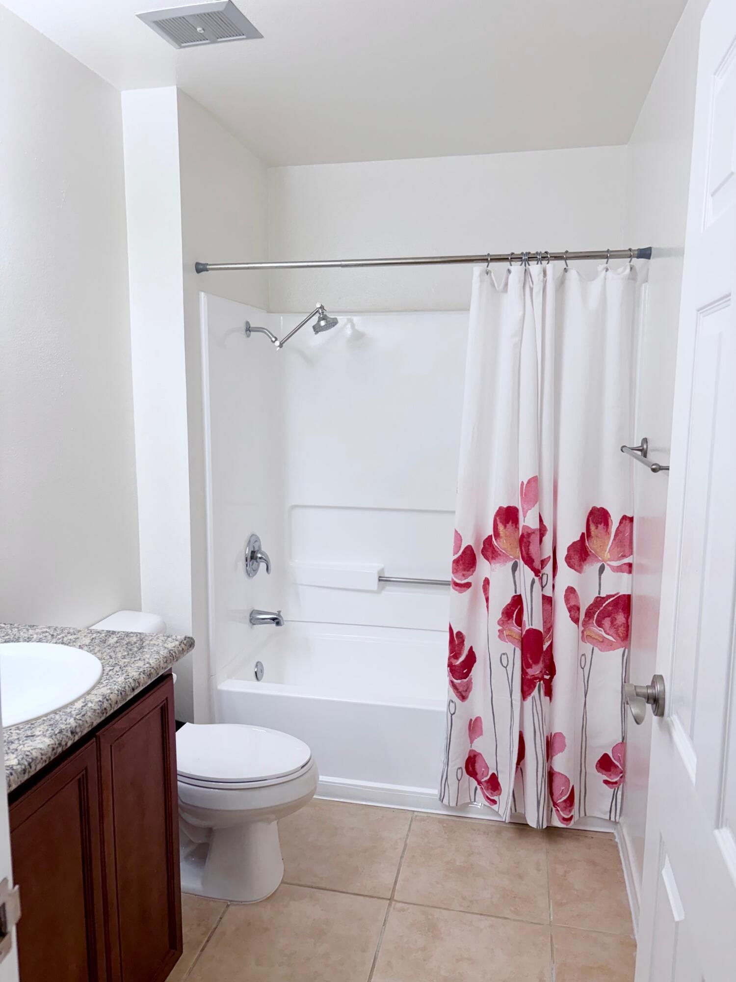 43376 Cook Street, Unit 32 Palm Desert, CA 92211 - Photo 16 of 31 a bathroom with a bathtub sink vanity mirror and toilet