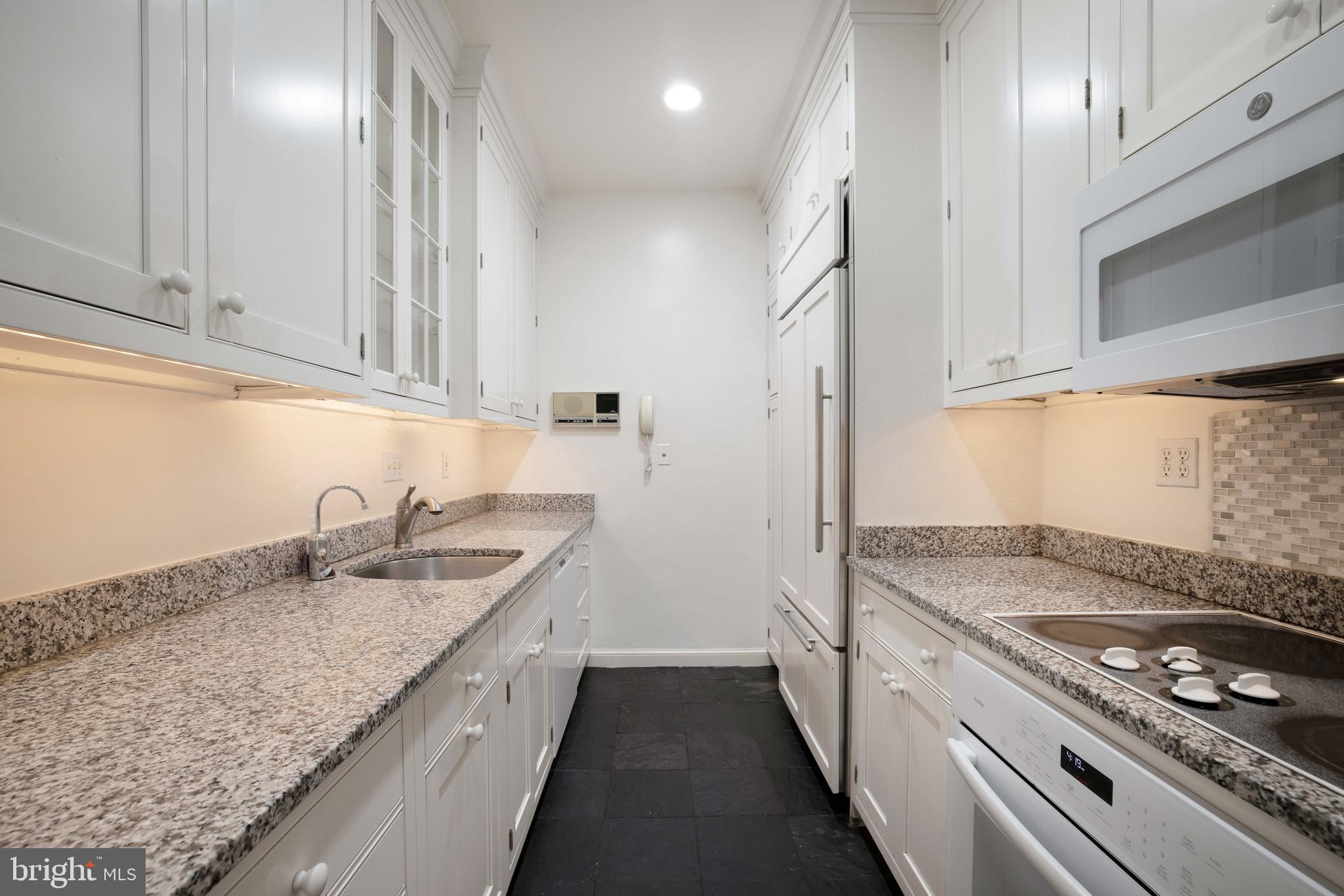 3327 R Street Northwest Washington, DC 20007 - Photo 14 of 39 a kitchen with granite countertop a sink stove and cabinets