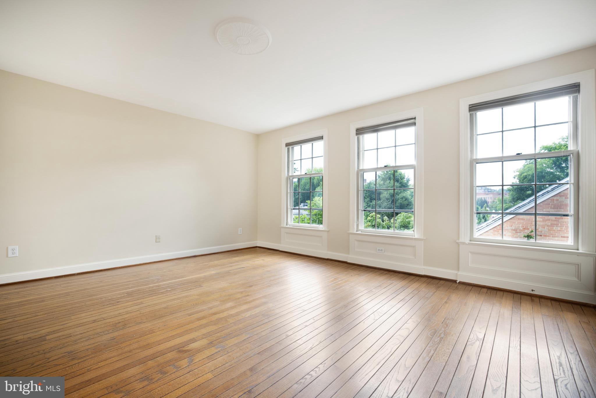 3327 R Street Northwest Washington, DC 20007 - Photo 17 of 39 an empty room with wooden floor and windows