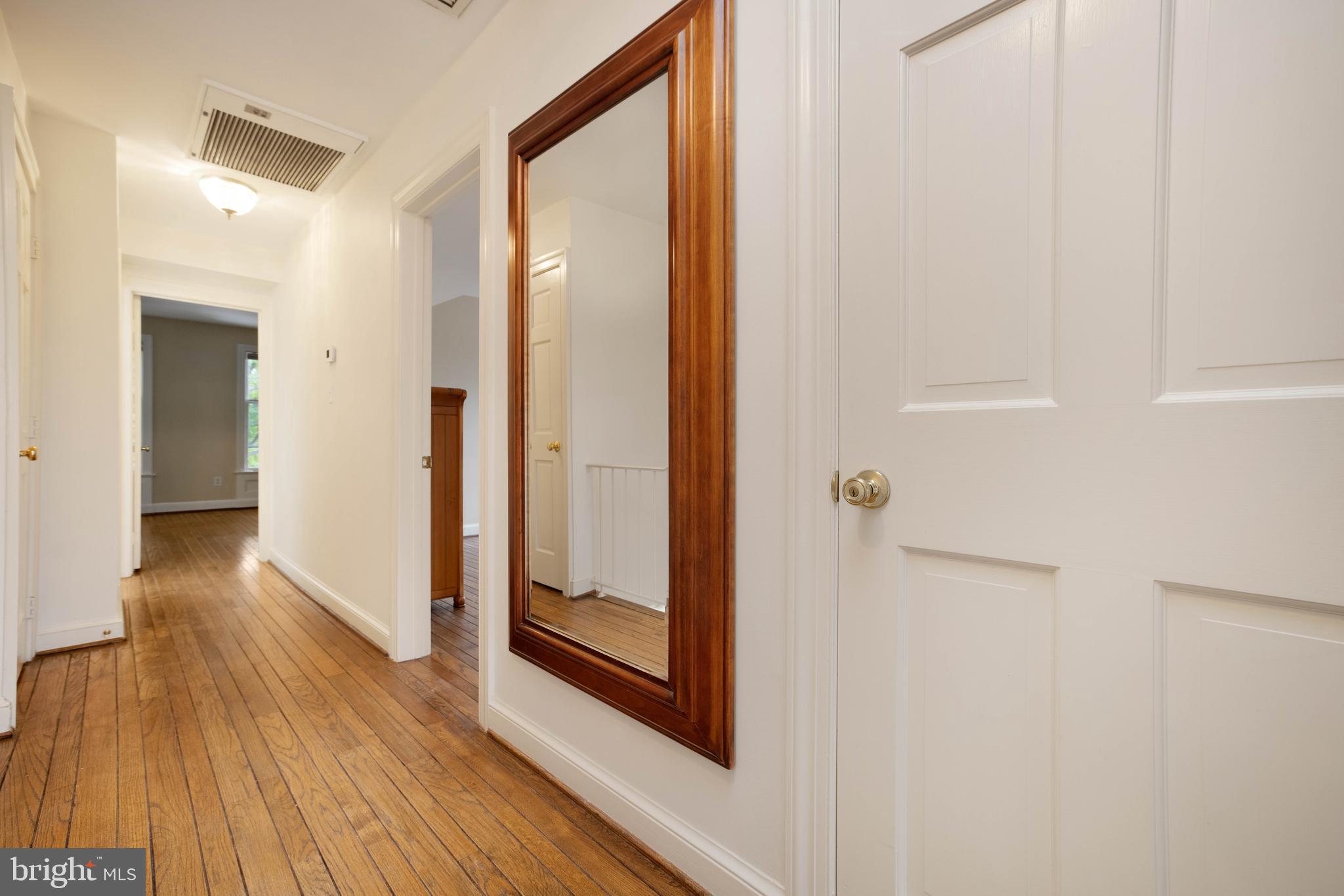 3327 R Street Northwest Washington, DC 20007 - Photo 21 of 39 a view of a hallway with wooden floor