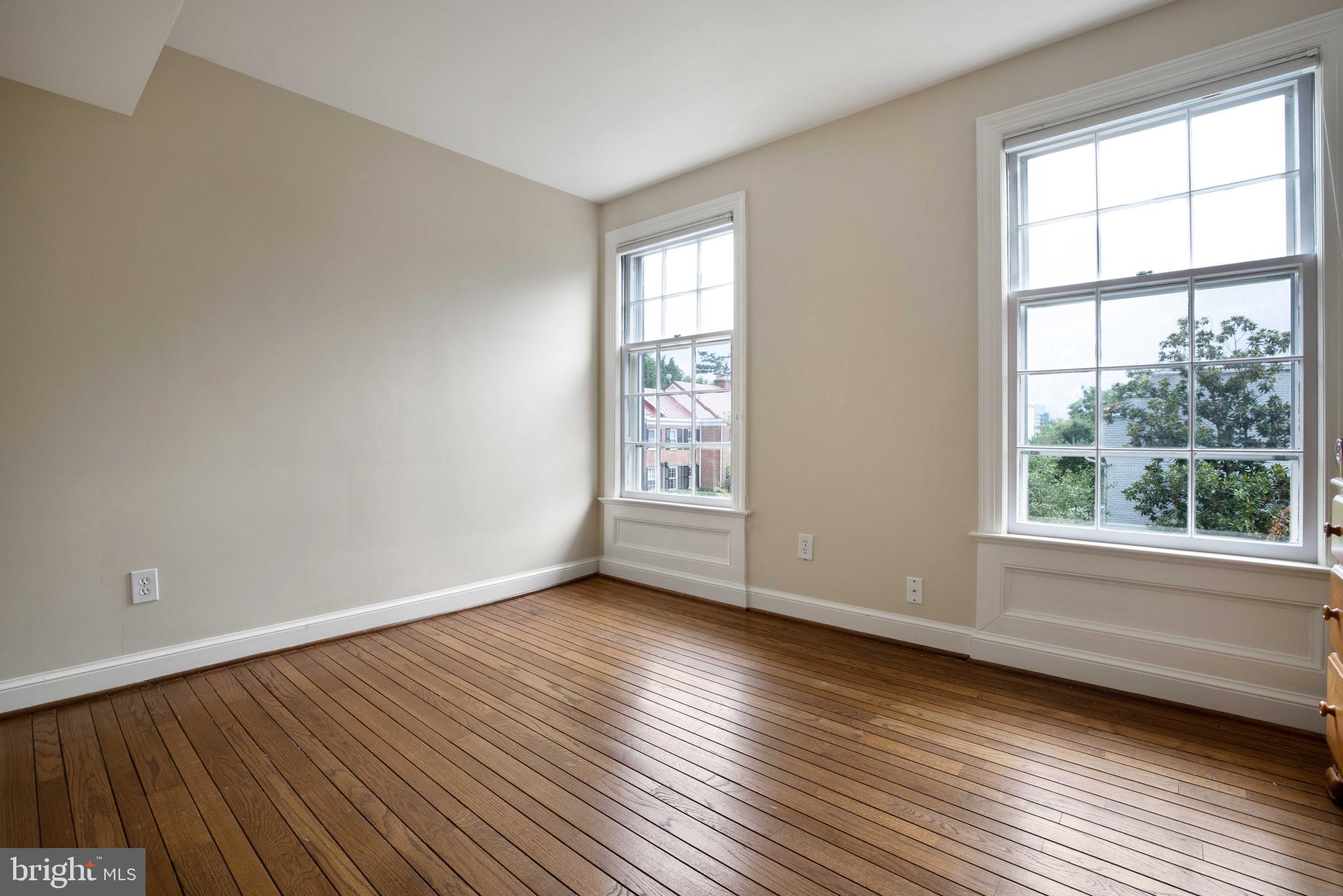 3327 R Street Northwest Washington, DC 20007 - Photo 22 of 39 a view of an empty room with wooden floor and a window