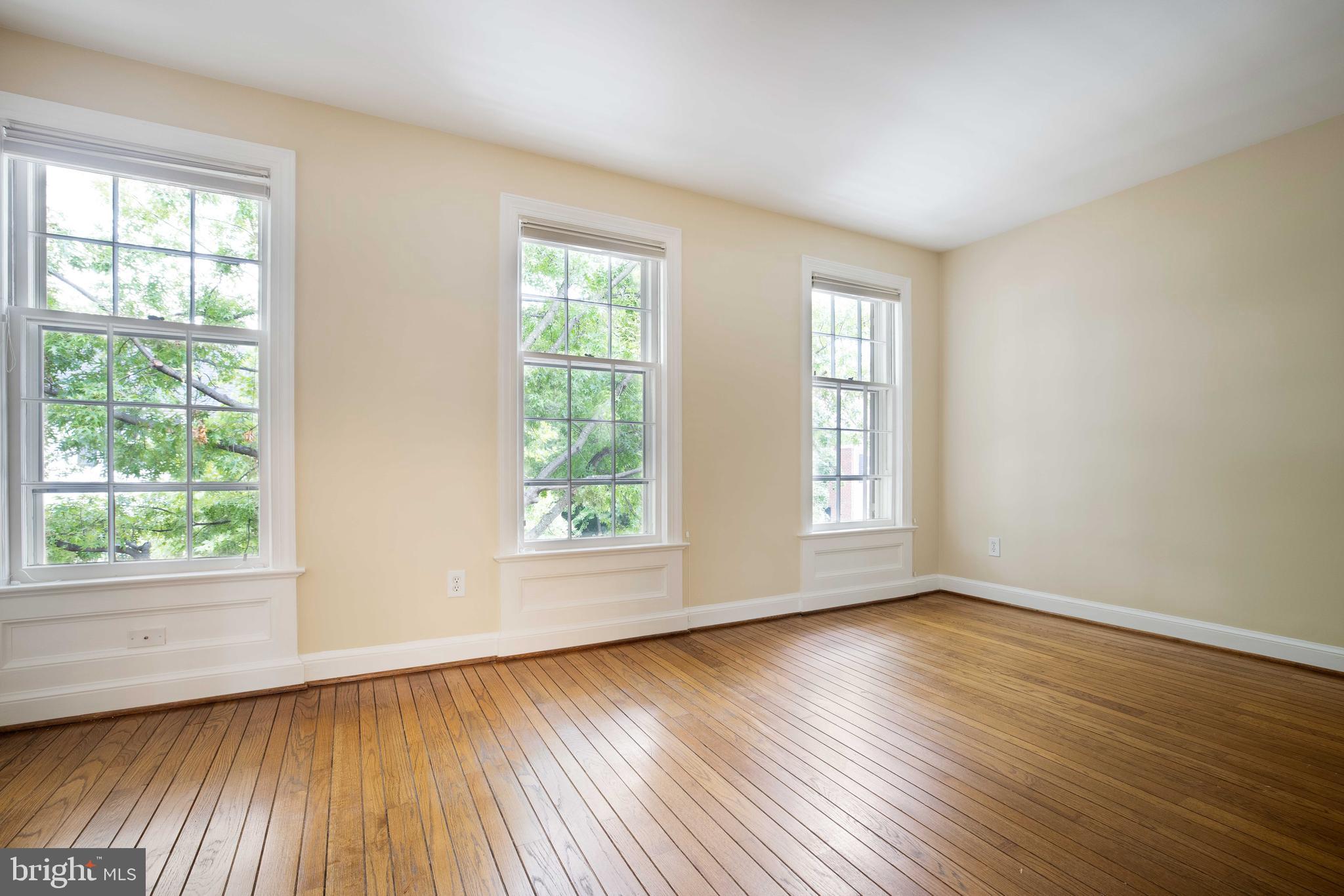 3327 R Street Northwest Washington, DC 20007 - Photo 25 of 39 a view of an empty room with wooden floor and a window