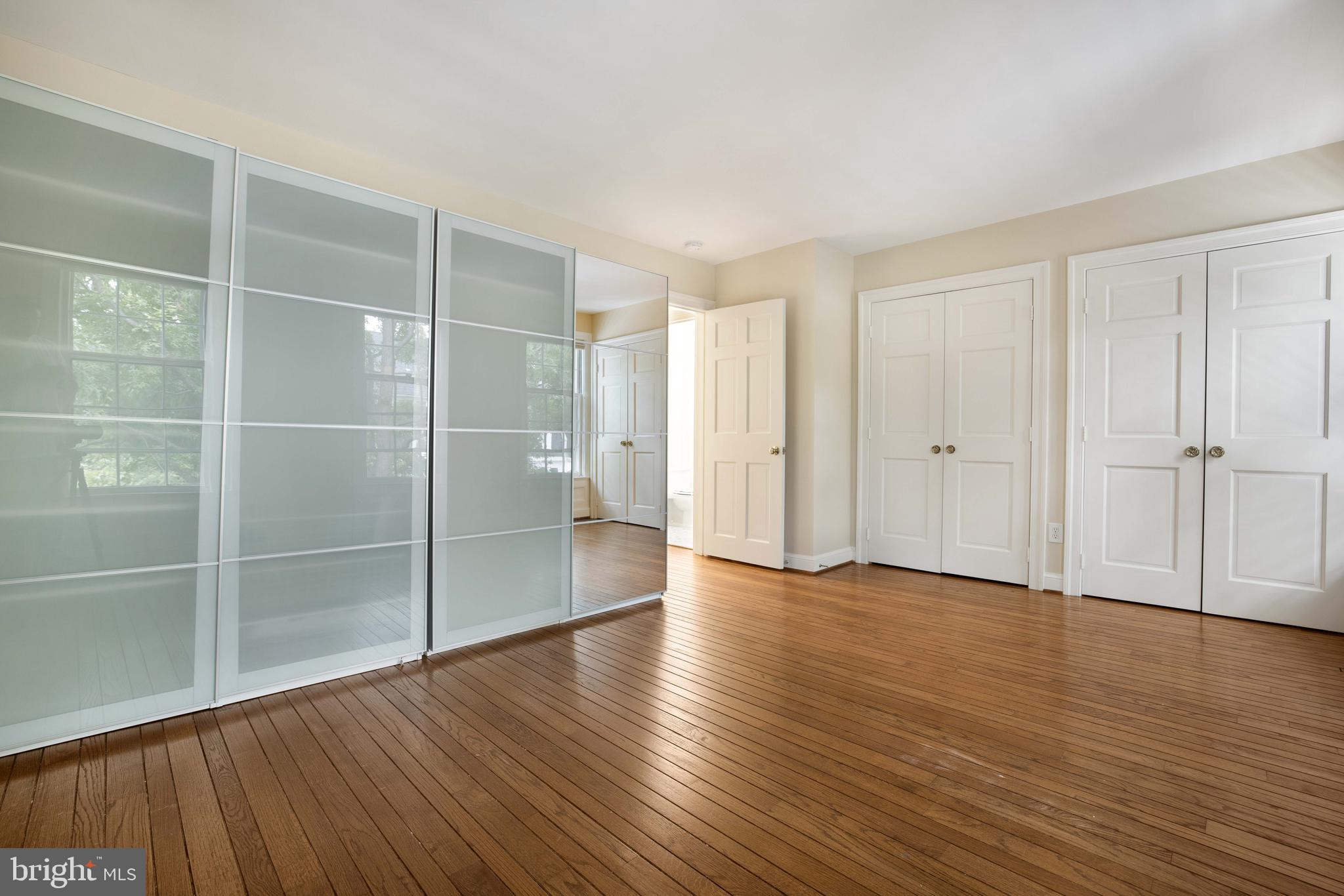 3327 R Street Northwest Washington, DC 20007 - Photo 26 of 39 a view of an empty room with wooden floor and a window