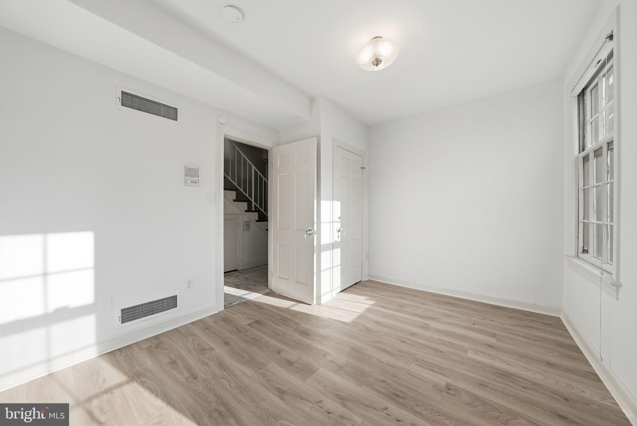 3327 R Street Northwest Washington, DC 20007 - Photo 30 of 39 wooden floor in an empty room with a window