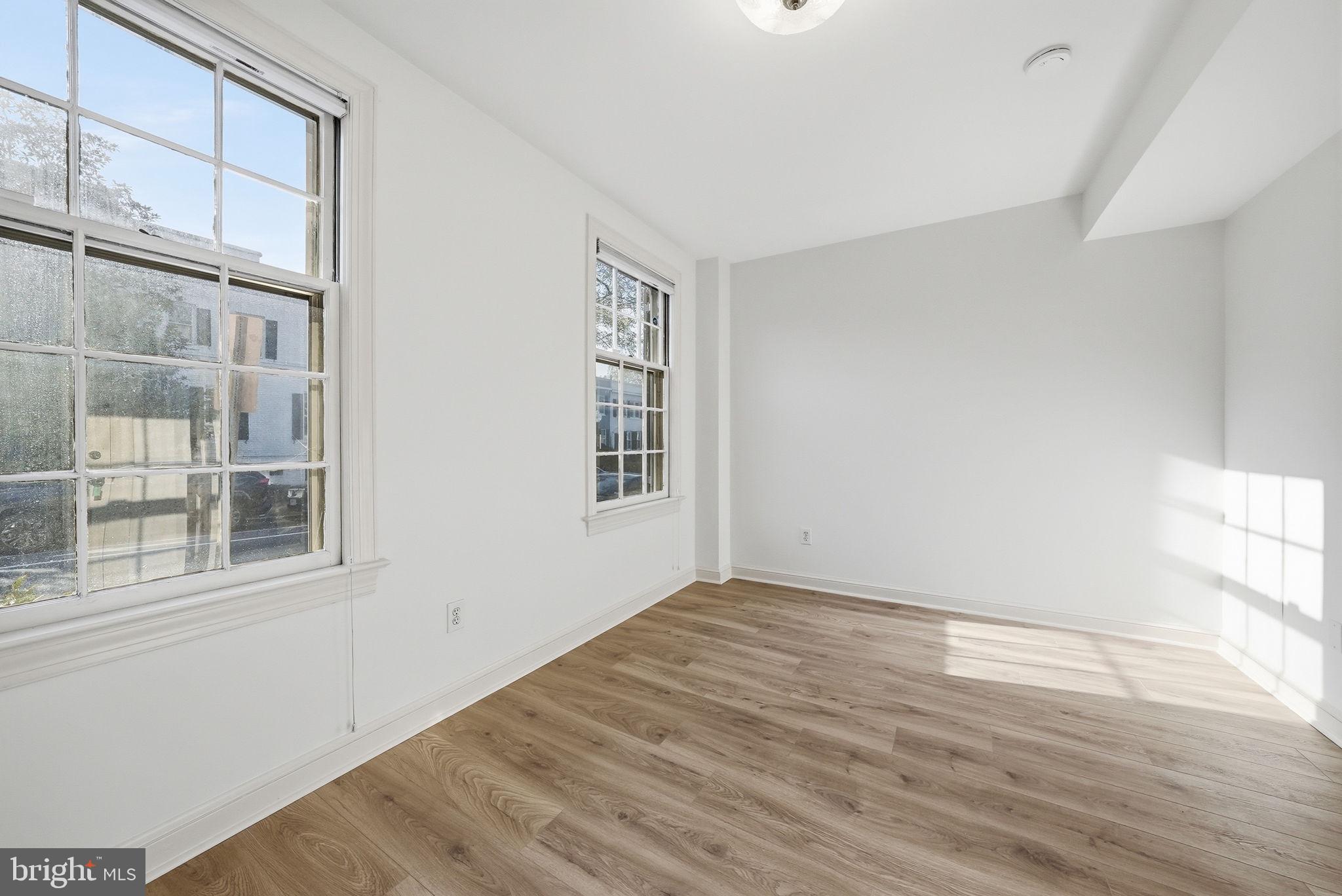 3327 R Street Northwest Washington, DC 20007 - Photo 31 of 39 a view of an empty room with wooden floor and a window