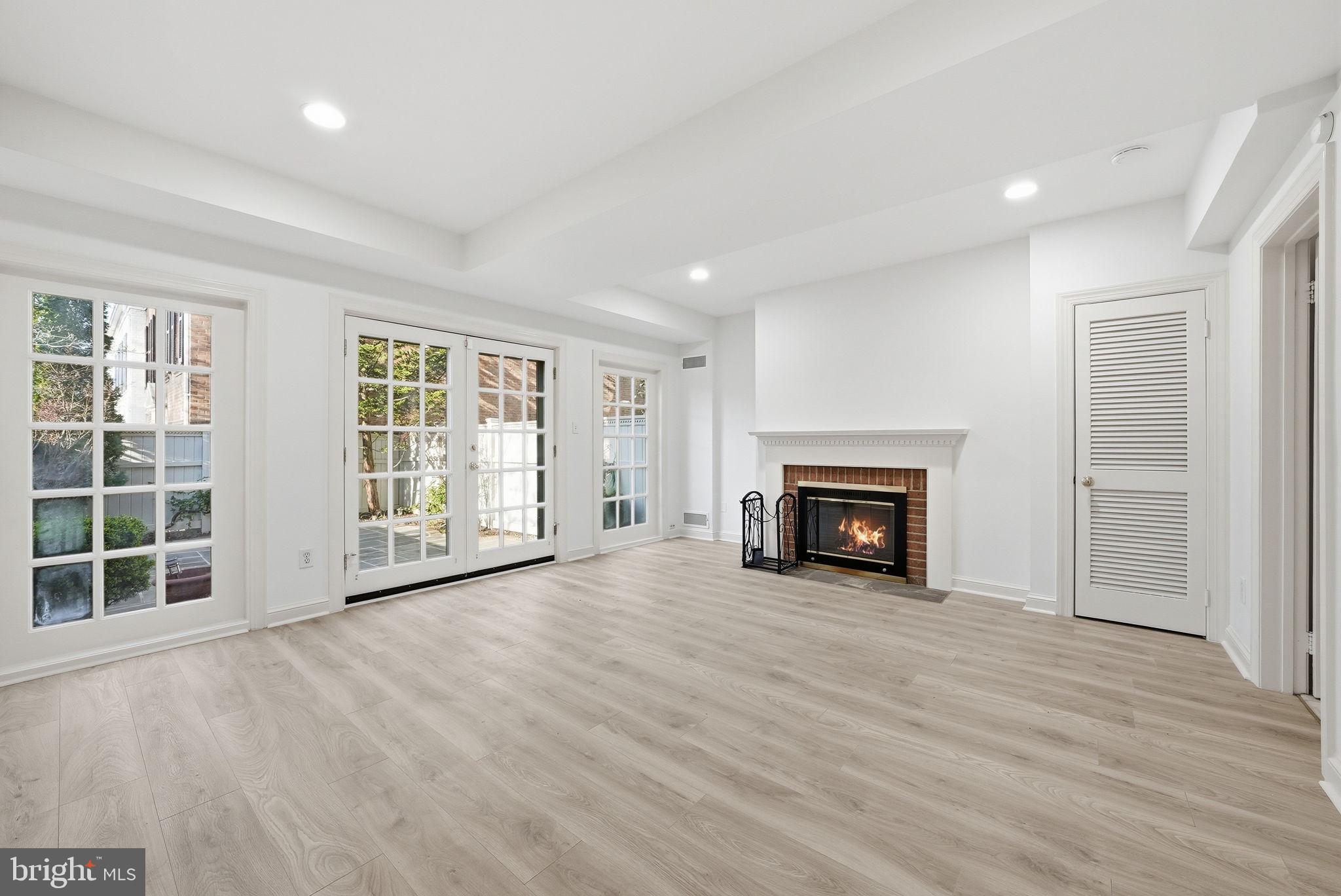 3327 R Street Northwest Washington, DC 20007 - Photo 32 of 39 an empty room with windows and fireplace