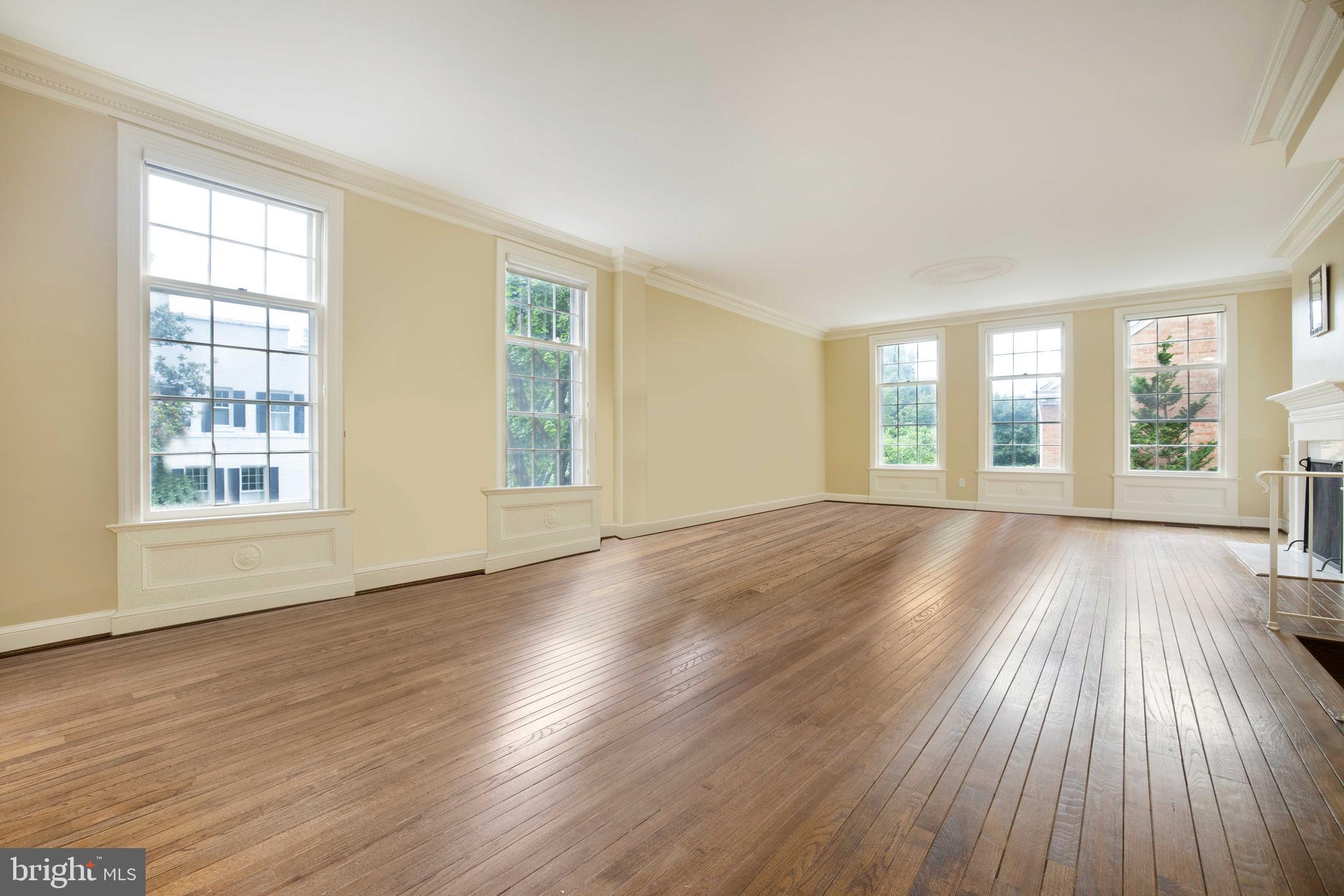 3327 R Street Northwest Washington, DC 20007 - Photo 6 of 39 a view of an empty room with wooden floor and a window