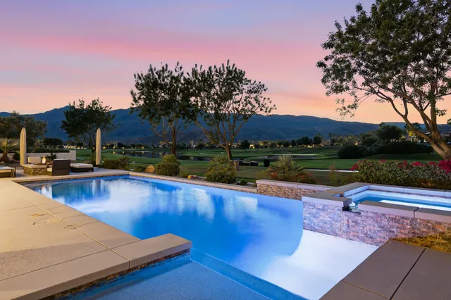 a view of swimming pool with outdoor seating and yard in the back