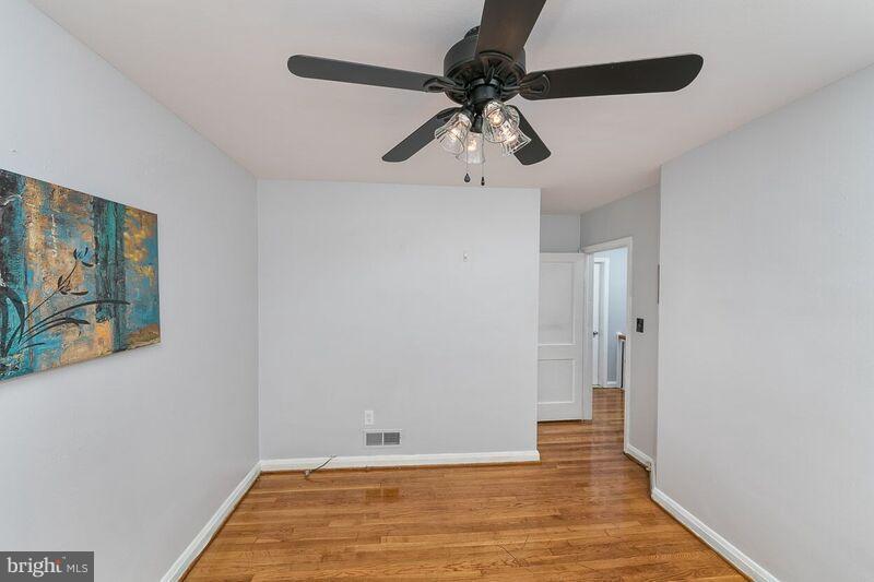 6202 Falkirk Road Baltimore, MD 21239 - Photo 14 of 22 a view of an empty room with wooden floor