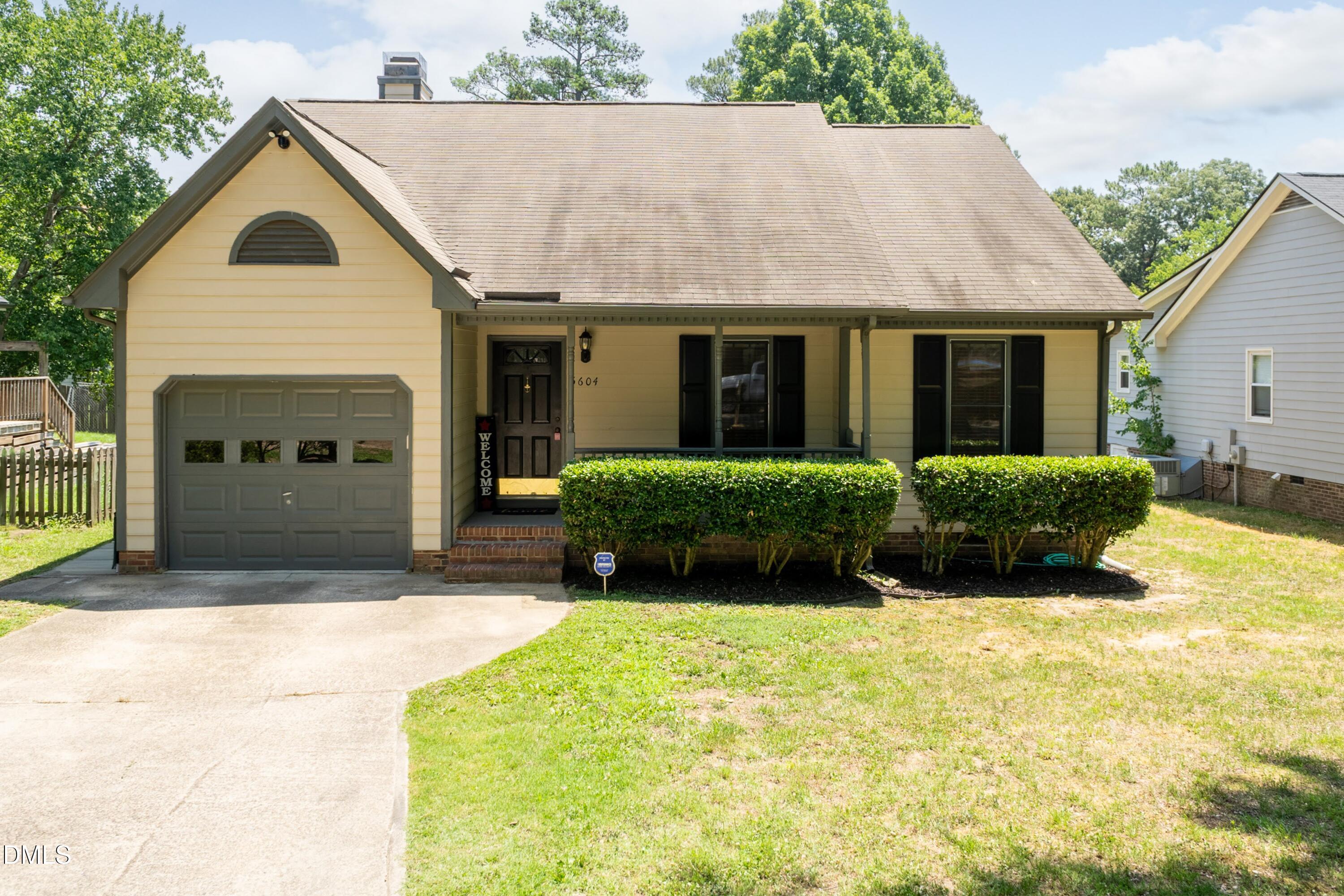 5604 Spring Pines Way Raleigh, NC 27616 - Photo 1 of 22 a front view of a house with a yard and potted plants