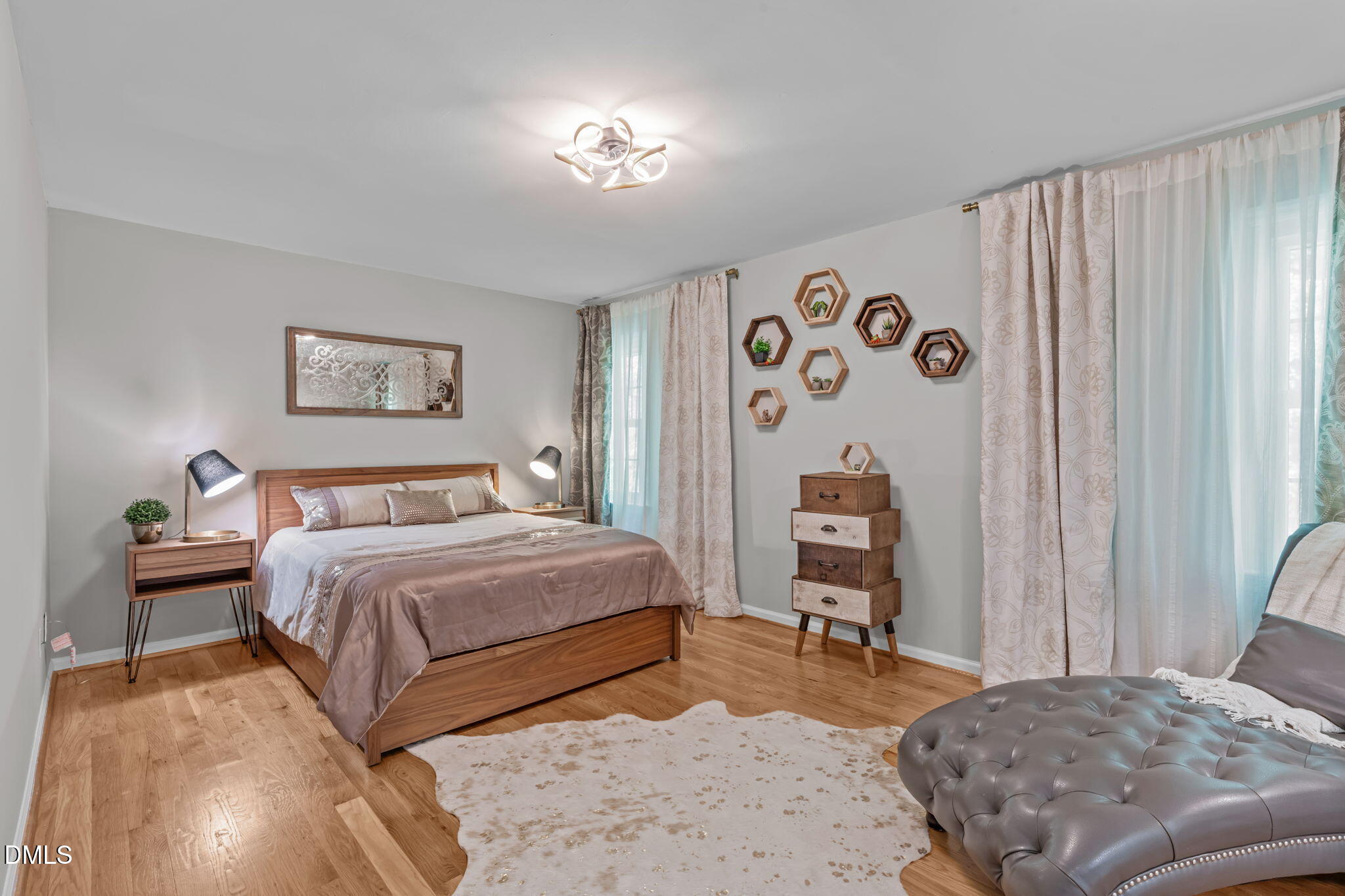 104 Lost Tree Lane Cary, NC 27513 - Photo 20 of 54 a bedroom with a bed and a chandelier