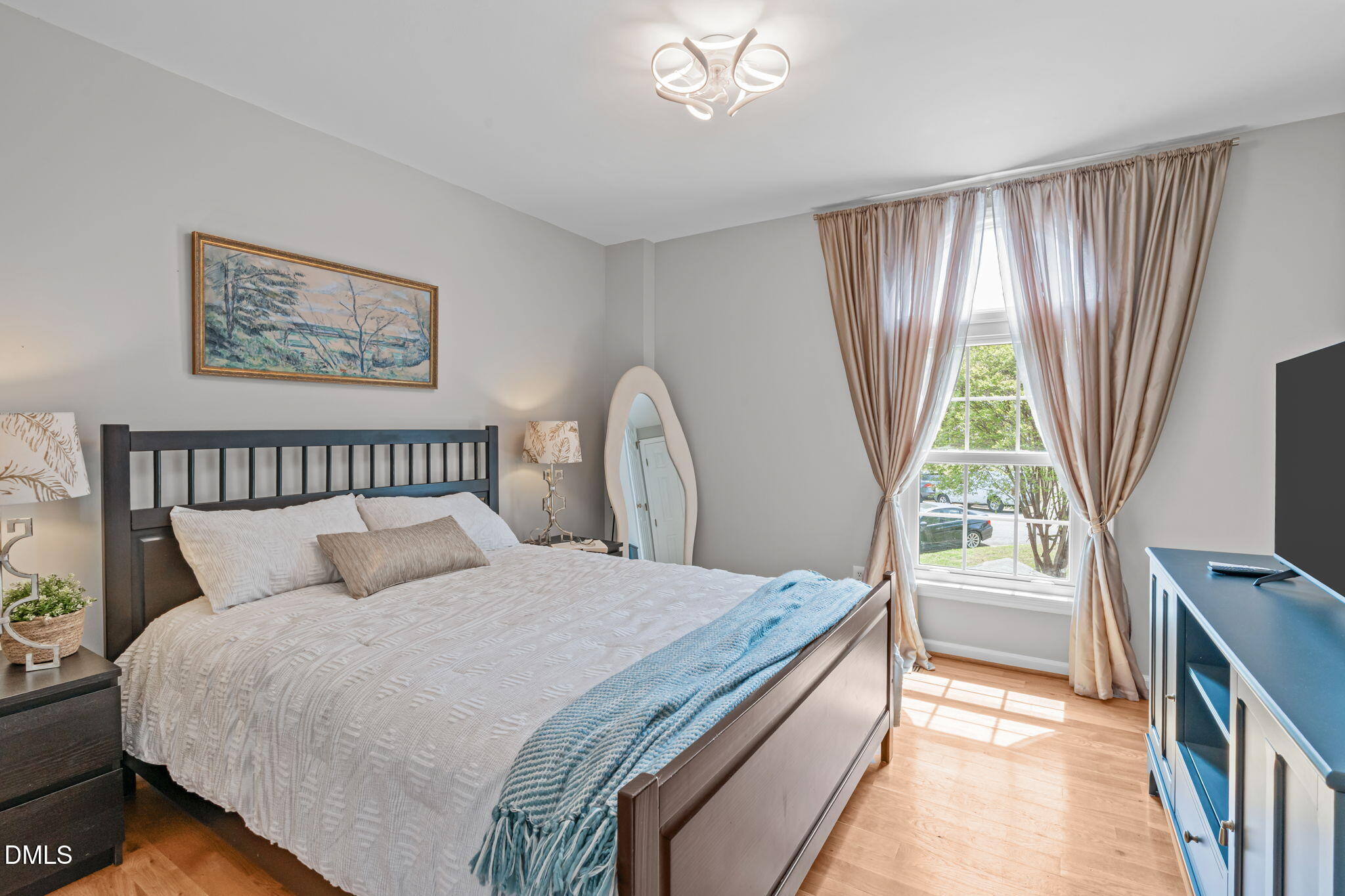 104 Lost Tree Lane Cary, NC 27513 - Photo 29 of 54 a bedroom with a bed and a flat screen tv