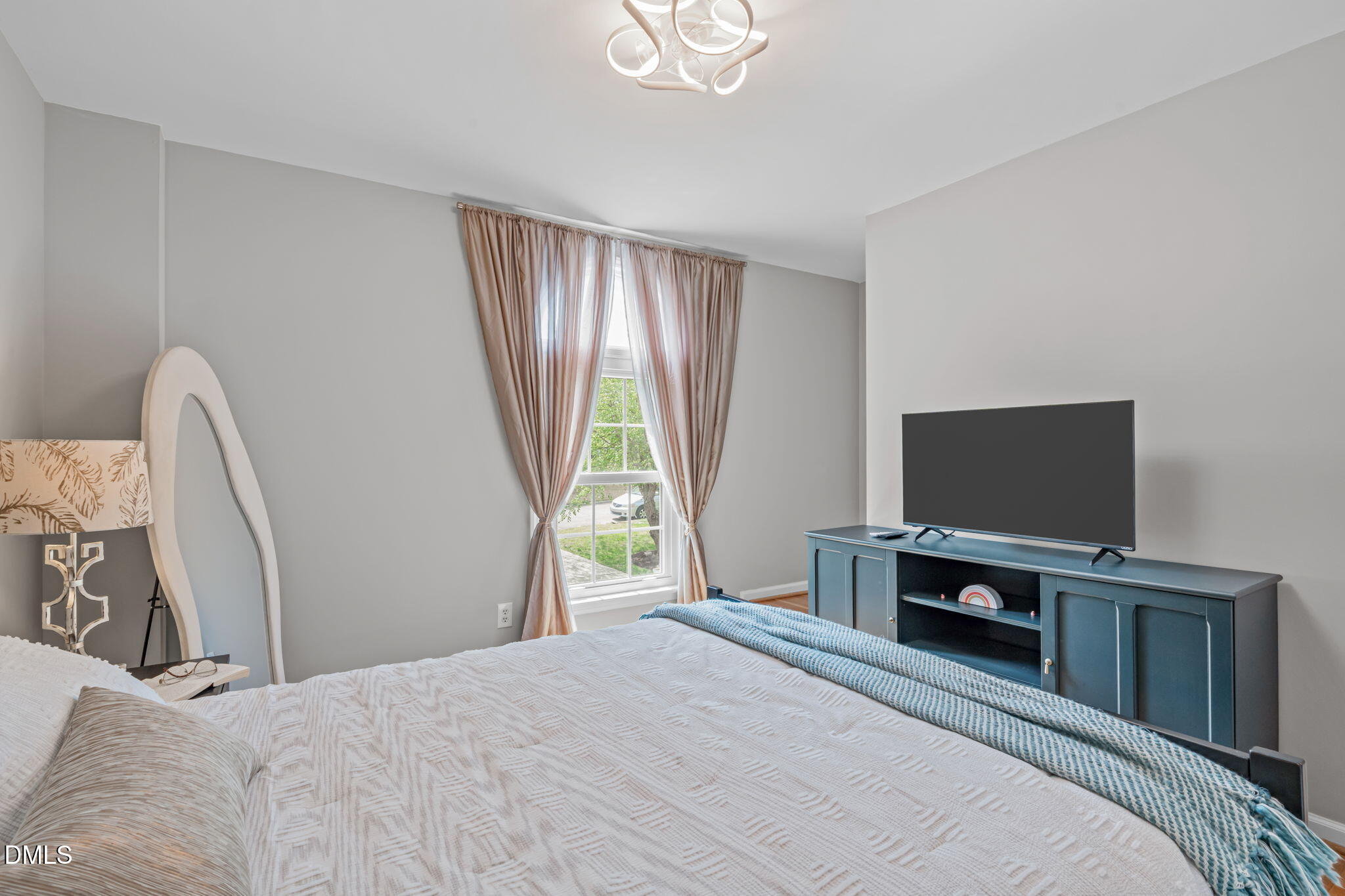 104 Lost Tree Lane Cary, NC 27513 - Photo 30 of 54 a bedroom with a bed and a flat screen tv