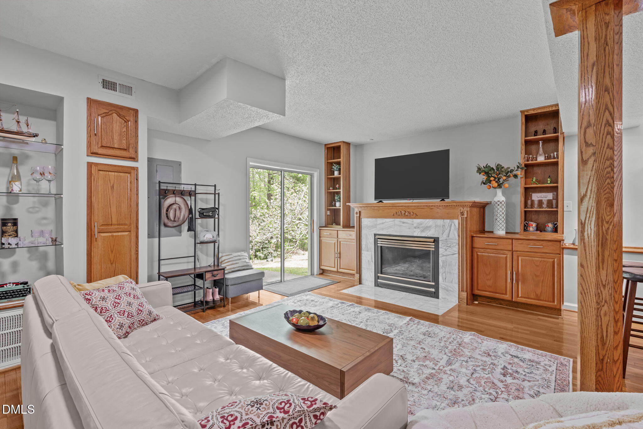 104 Lost Tree Lane Cary, NC 27513 - Photo 35 of 54 a living room with furniture a flat screen tv and a fireplace