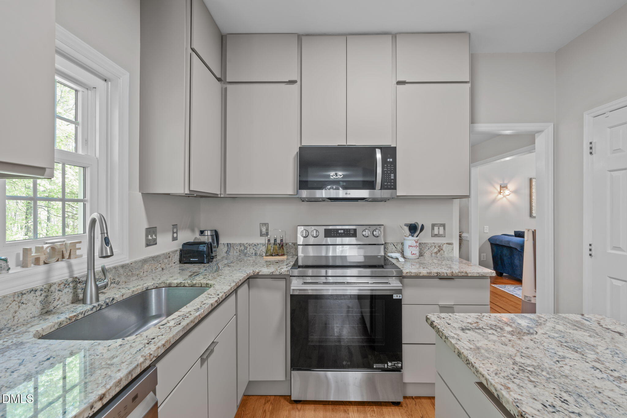 104 Lost Tree Lane Cary, NC 27513 - Photo 6 of 54 a kitchen with stainless steel appliances granite countertop a sink stove and microwave
