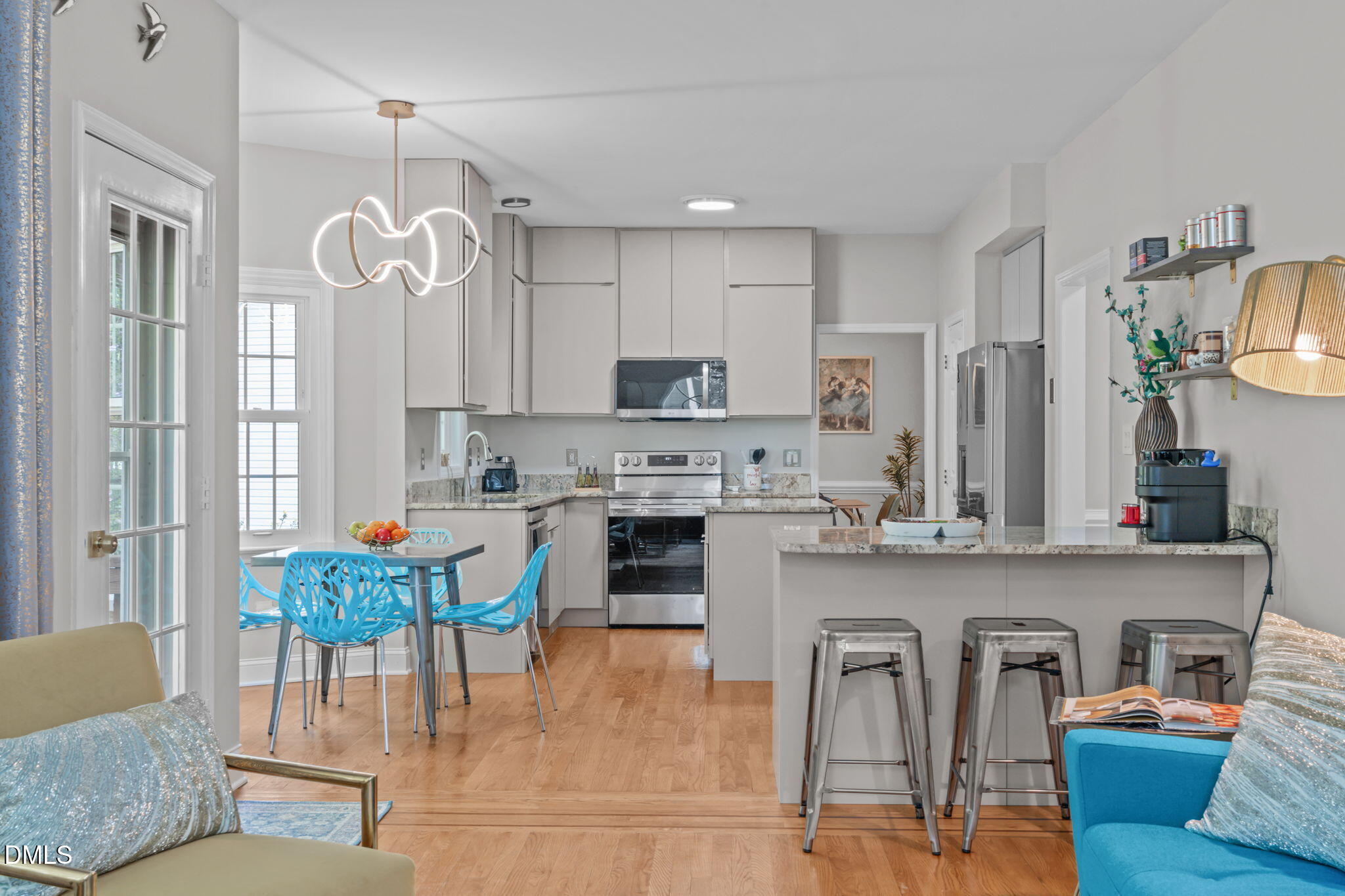 104 Lost Tree Lane Cary, NC 27513 - Photo 9 of 54 a kitchen with stainless steel appliances kitchen island granite countertop a refrigerator a stove top oven a sink dishwasher and white cabinets with wooden floor