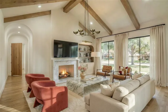 a living room with furniture fireplace and flat screen tv