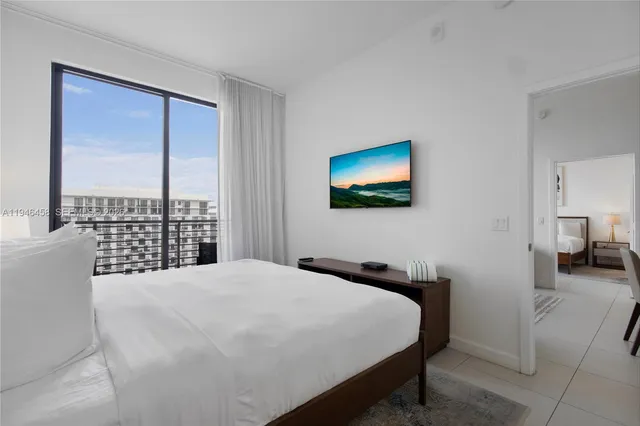 a bedroom with a bed and a painting on the wall