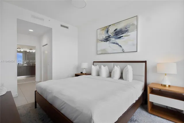 a bathroom with a granite countertop sink a mirror and a shower