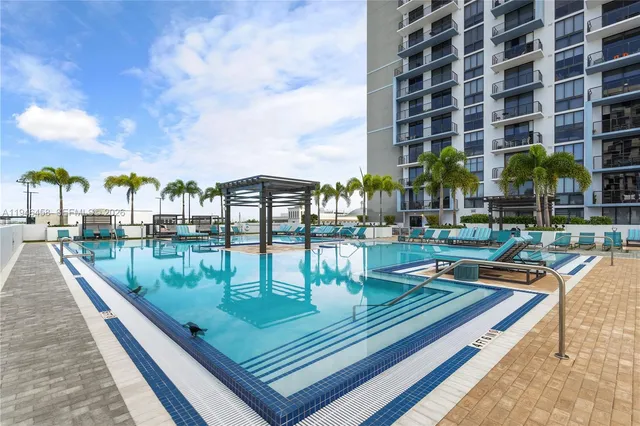 a view of swimming pool with outdoor seating and city view