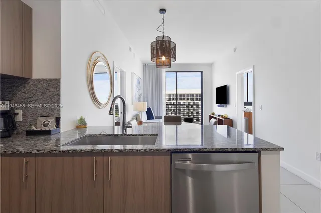 a kitchen with granite countertop a stove a sink and a granite counter top