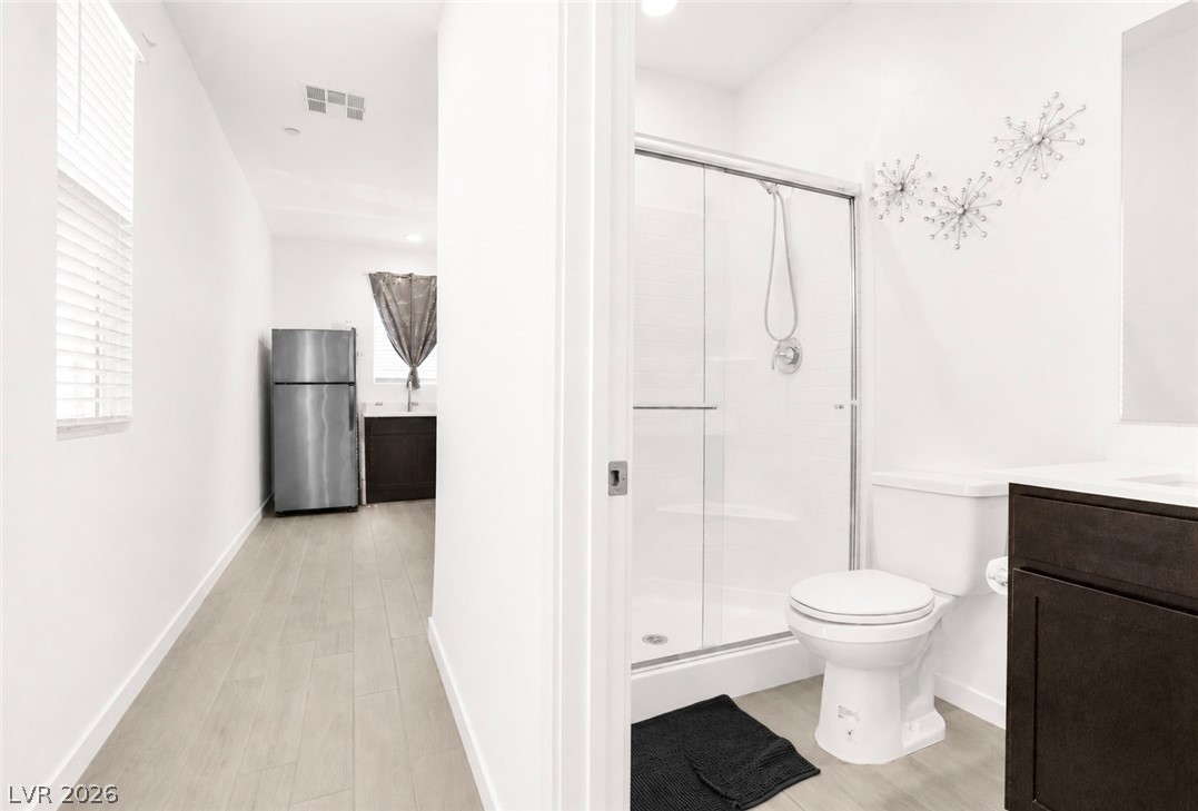 9398 Noble Fir Rdg Court Las Vegas, NV 89143 - Photo 24 of 36 Streamlined design with a full bathroom and an adjacent kitchen, providing practical living.