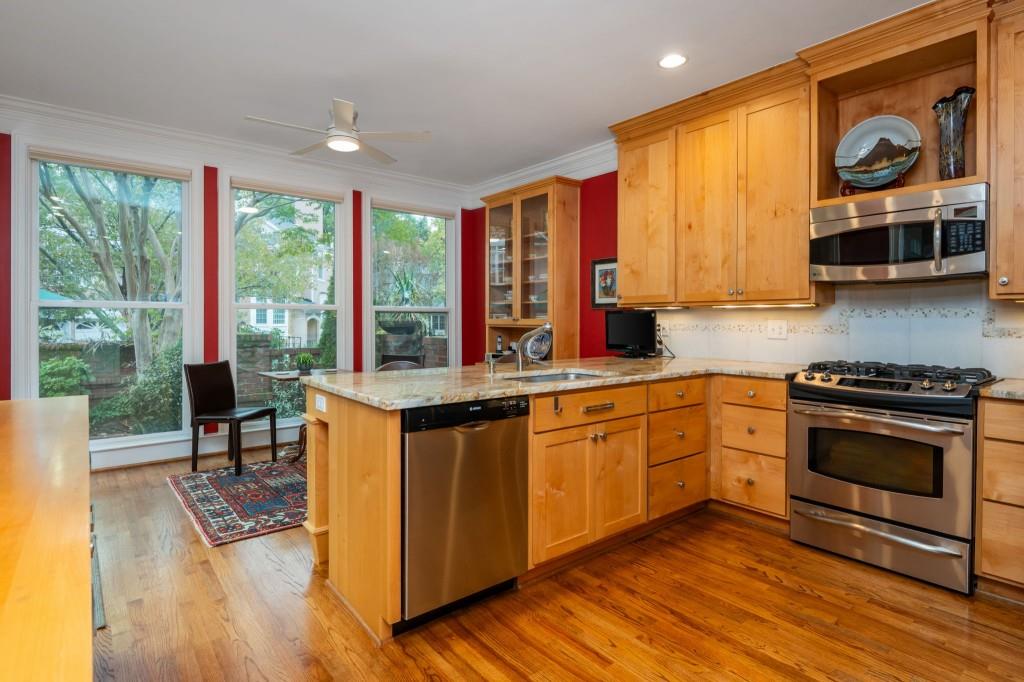 676 Clifton Road Northeast Atlanta, GA 30307 - Photo 15 of 45 a kitchen with stainless steel appliances granite countertop a stove a sink and a microwave