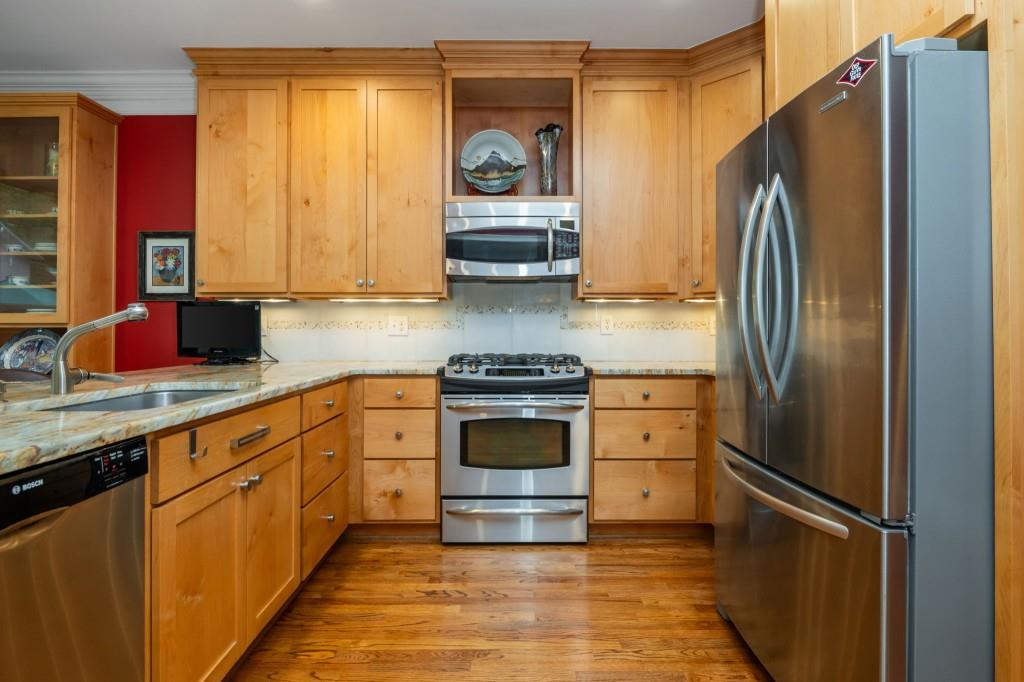 676 Clifton Road Northeast Atlanta, GA 30307 - Photo 17 of 45 a kitchen with stainless steel appliances granite countertop a refrigerator and a stove